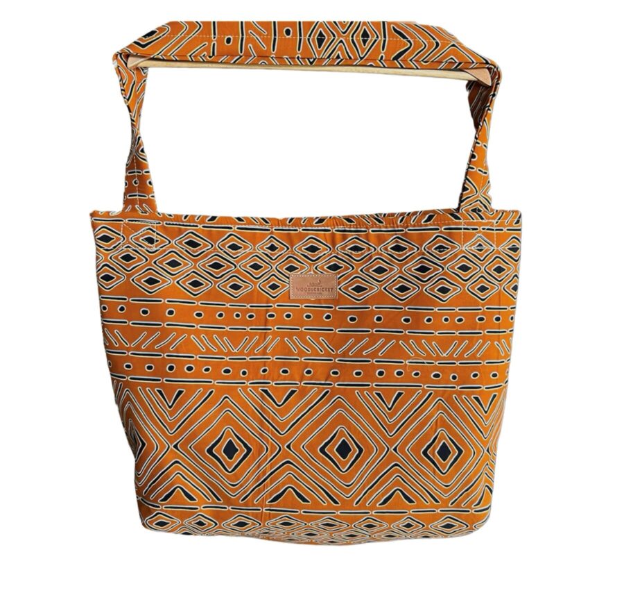 De Afrika tas is een handgemaakte tas uit de collectie van Wood & Cricket, de tas heeft een patroon van oranje, zwart en grijs